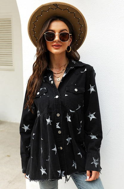 A woman wearing a black flounced star print denim shirt with a raw hem and a flat brim fedora