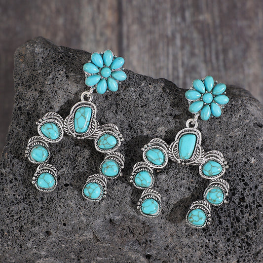 A pair of horseshoe shaped faux turquoise fashion jewelry earrings