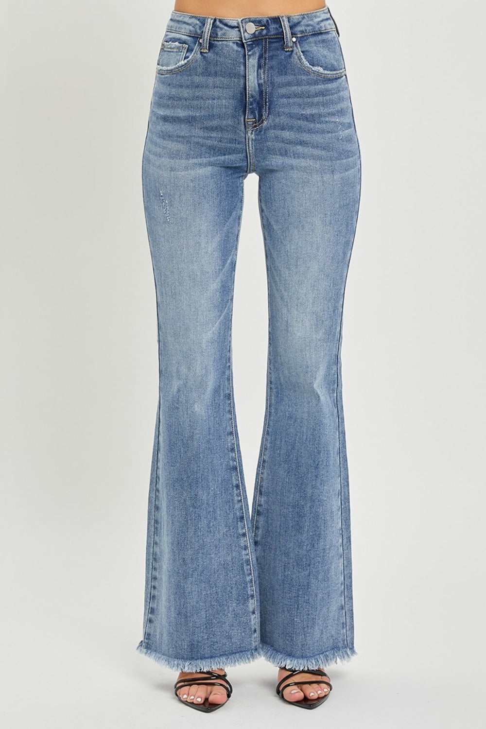 A medium wash pair of classic flare leg distressed hem jeans by RISEN.