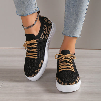 A pair of ultra-lightweight women's black leopard print sneakers