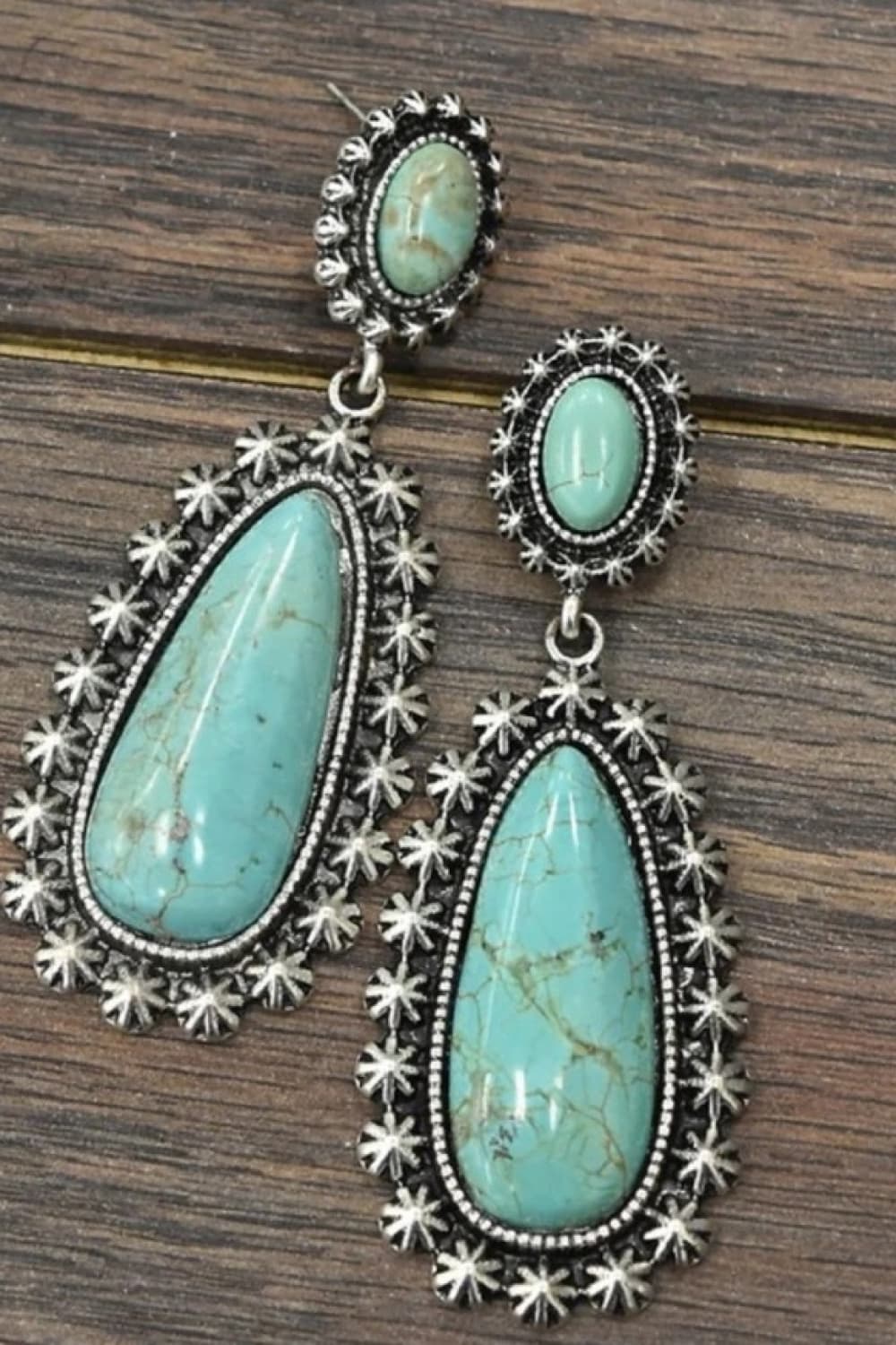 A pear of teardrop shaped faux turquoise earrings