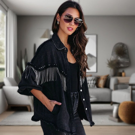 A black fringe denim jacket with silver metallic fringe on the front an arms, embellished by silver studs