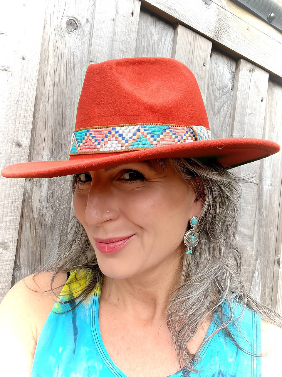 A woman wearing The Desperado Western Fedora in color Rust Red.