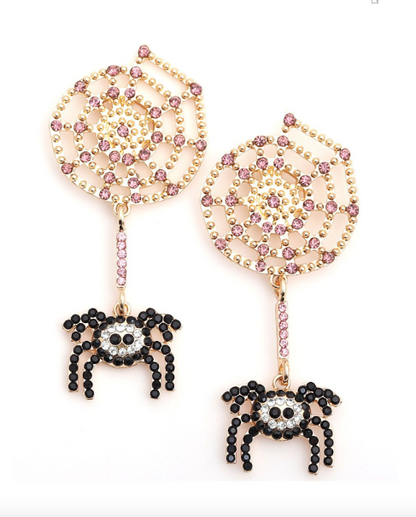 An adorable pair of rhinestone earrings featuring a gold and rhinestone spider web and a black spider dangling from a small chain.