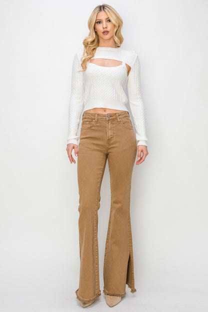 A front lower view of a woman wearing a pair of brown denim Durango slit flare jeans made by Risen.