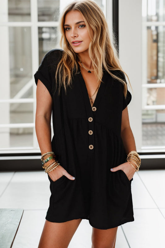 A women wearing a black empire waist romper.