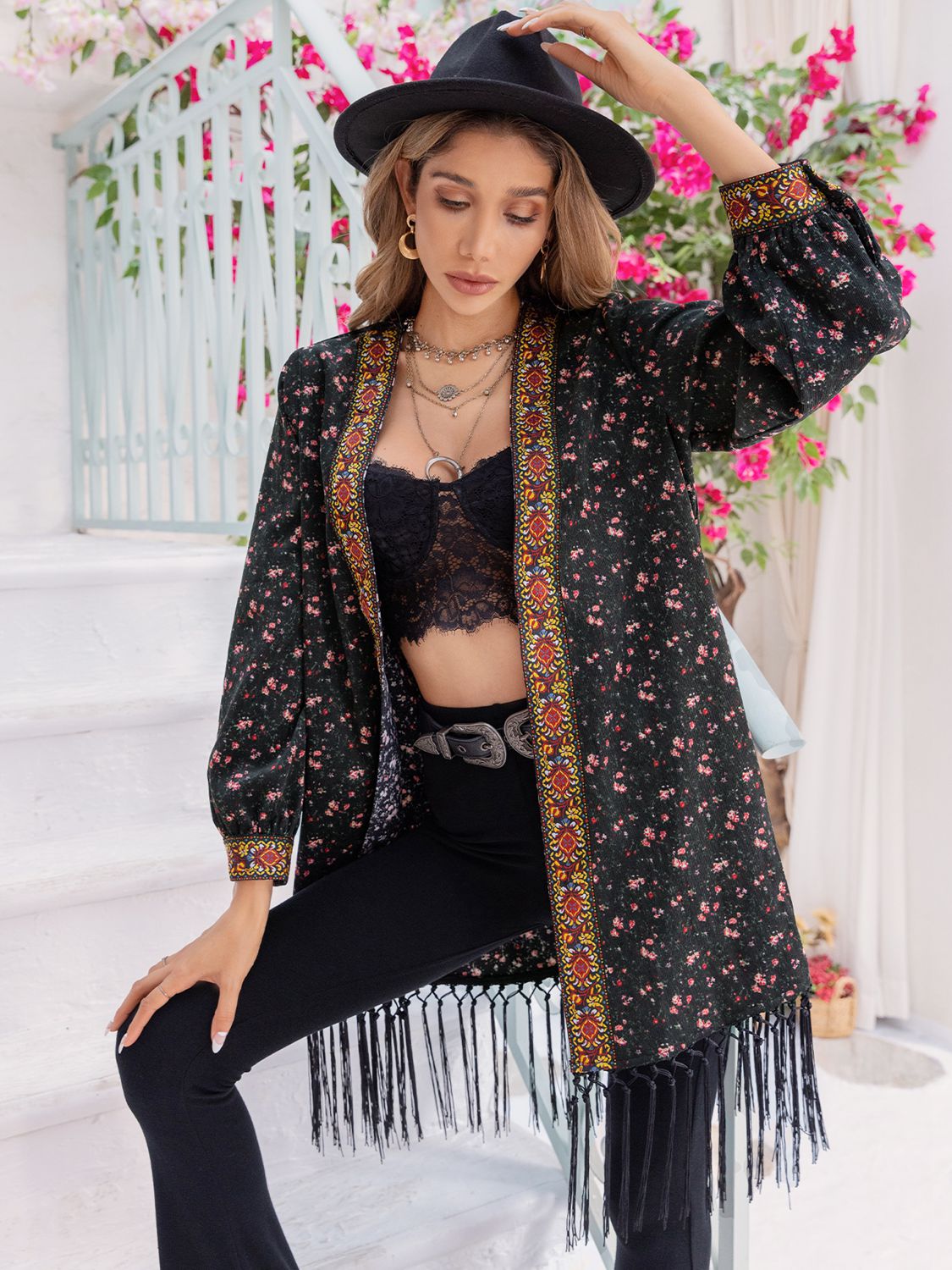 A woman wearing a fringed boho cardigan