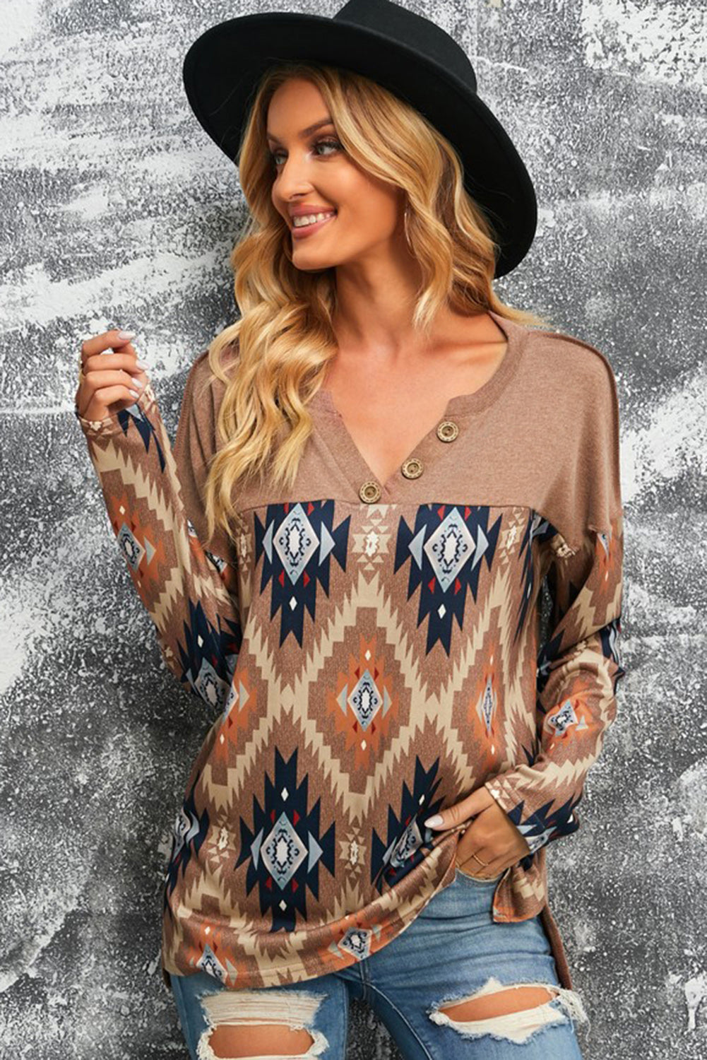 A woman wearing the Delgada Western Aztec Print Mock Henley with a pair of distressed jeans and a Western felt fedora.