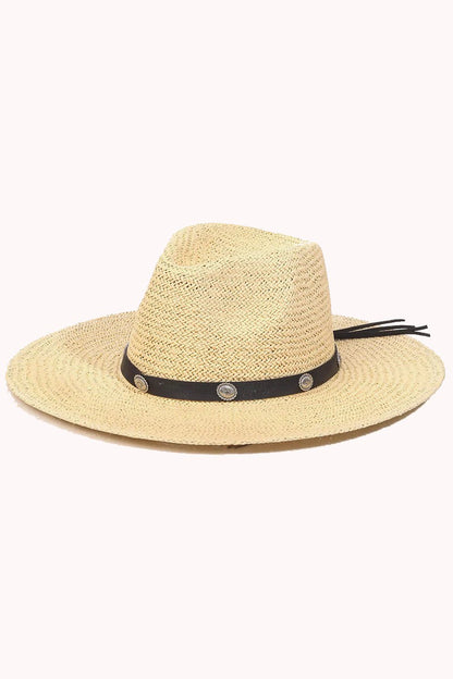 a straw Western fedora with a concho-embellished hat band