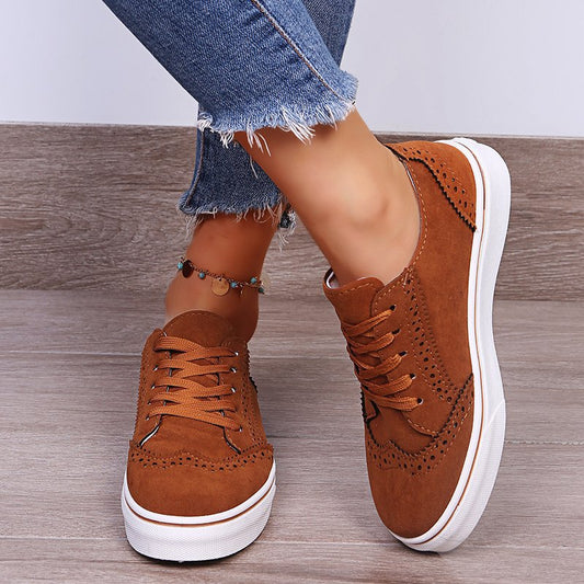 A pair of vegan friendly suedette cushioned sneakers with wing tip styling.