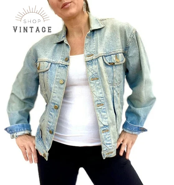 A woman wearing a light wash, relaxed fit vintage denim jacket